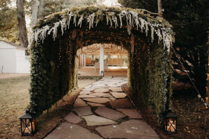 Flanked by black lanterns, view of entrance to pavilion at Country Villa Weddings and Events.
