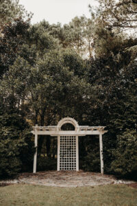 Close-up view of white lattice wedding altar with cobbled stones at Country Villa Weddings and Events.