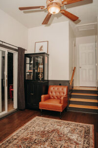 Burnt Orange color leather chair in grooms' lounge at Country Villa Weddings and Events